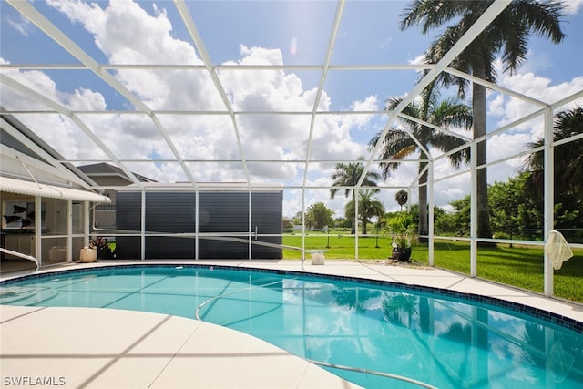 view of pool featuring a lawn and glass enclosure