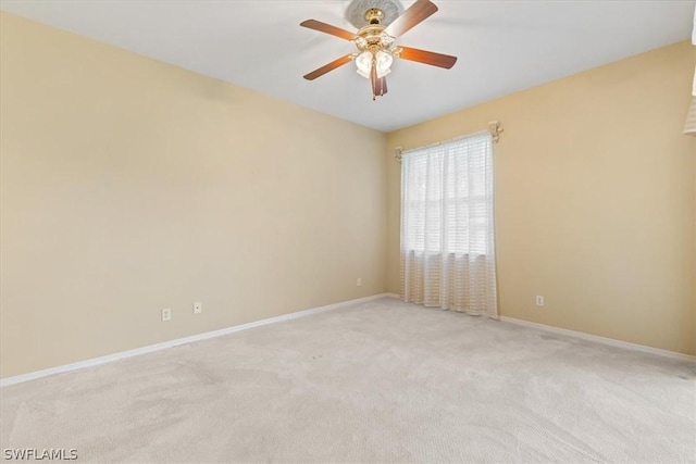 spare room featuring ceiling fan and light carpet