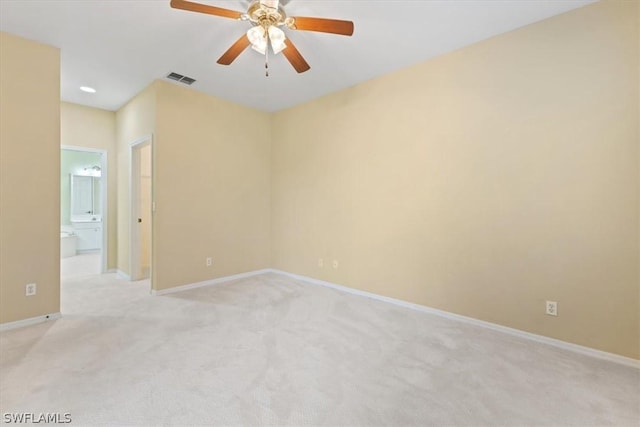 unfurnished room with light colored carpet and ceiling fan