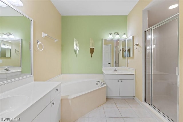 bathroom with tile patterned flooring, shower with separate bathtub, and vanity