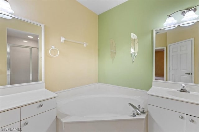 bathroom with separate shower and tub and vanity