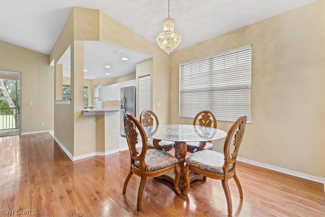 dining room with an inviting chandelier and light hardwood / wood-style floors