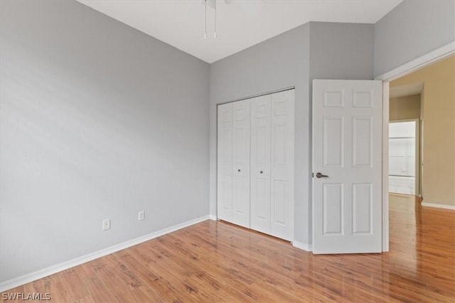 unfurnished bedroom with a closet and hardwood / wood-style floors