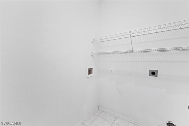 laundry area featuring hookup for an electric dryer, hookup for a washing machine, and light tile patterned flooring