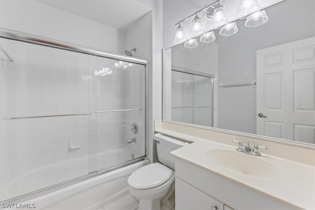 full bathroom featuring toilet, vanity, and combined bath / shower with glass door