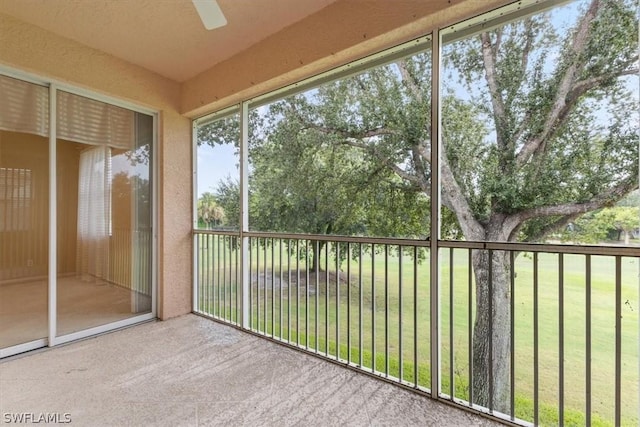 unfurnished sunroom with ceiling fan