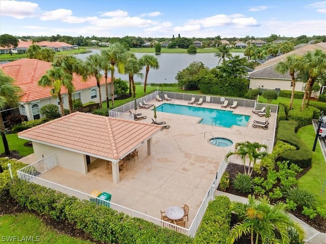 view of pool featuring a community hot tub, a patio area, and a water view