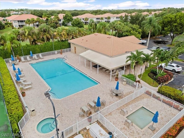 view of pool with a hot tub and a patio