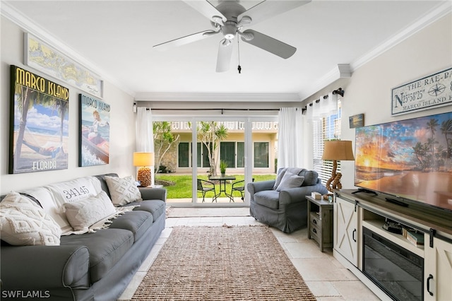 living room with ornamental molding, light tile patterned floors, and ceiling fan