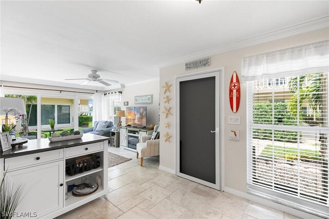 kitchen with light tile patterned flooring, white cabinetry, ceiling fan, and crown molding