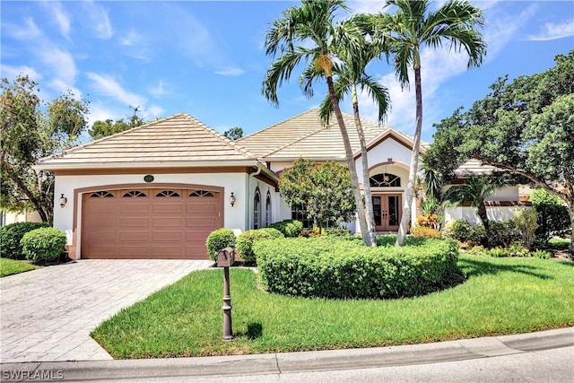 view of front of property featuring a garage and a front lawn