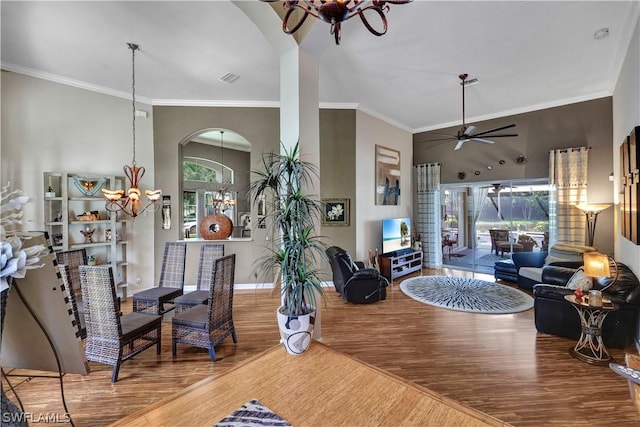 interior space featuring hardwood / wood-style flooring, ornamental molding, and ceiling fan with notable chandelier