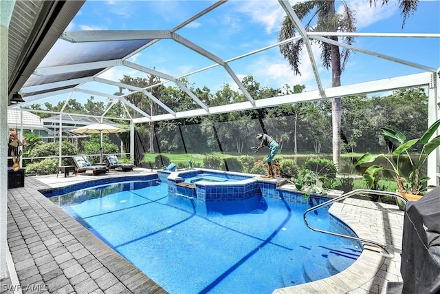 view of swimming pool featuring an in ground hot tub, a lanai, and a patio area