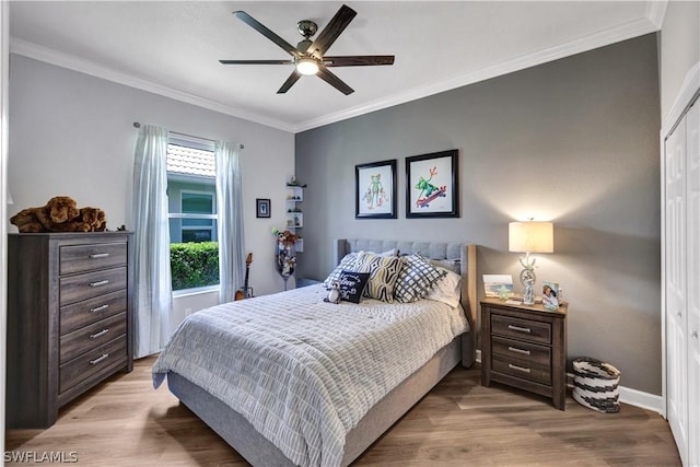 bedroom featuring ornamental molding, light hardwood / wood-style floors, and a closet