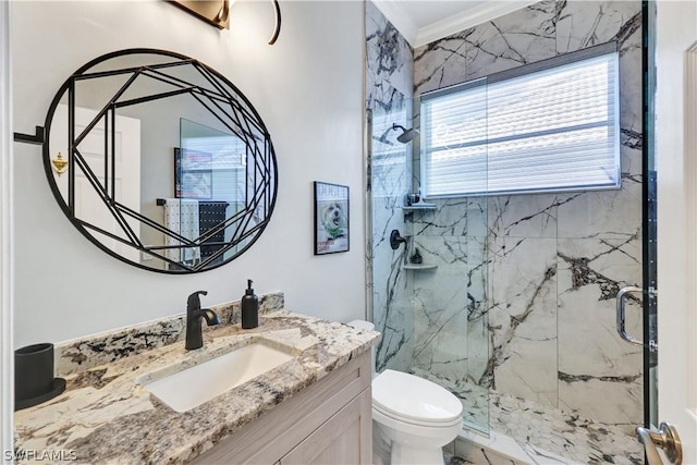 bathroom featuring vanity, crown molding, a shower with shower door, and toilet