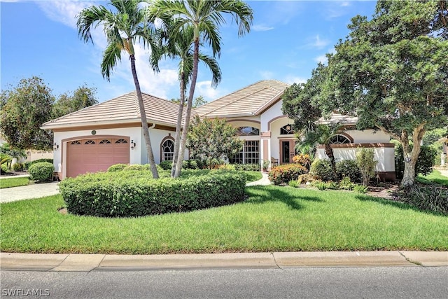 view of front of home with a garage and a front yard