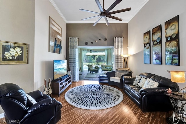 living room featuring hardwood / wood-style flooring, crown molding, and ceiling fan