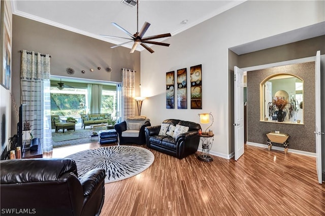 living room featuring hardwood / wood-style flooring, ceiling fan, and ornamental molding