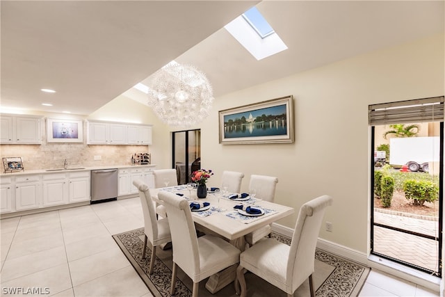 dining room featuring light tile patterned flooring, lofted ceiling with skylight, plenty of natural light, and a chandelier