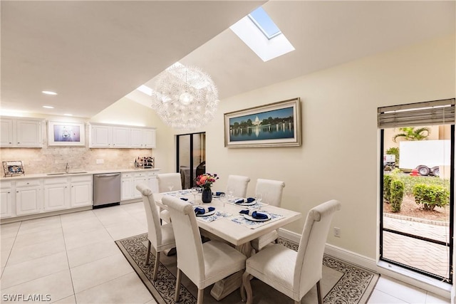 tiled dining area with sink and vaulted ceiling