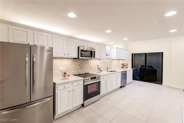 kitchen featuring tasteful backsplash, light tile patterned floors, white cabinets, stainless steel appliances, and sink