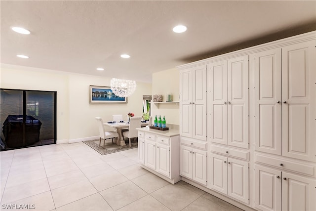 kitchen with light tile patterned flooring and white cabinetry