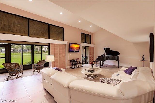 living room featuring tile patterned floors and high vaulted ceiling