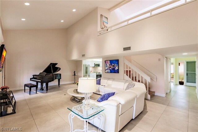 tiled living room featuring beam ceiling and high vaulted ceiling