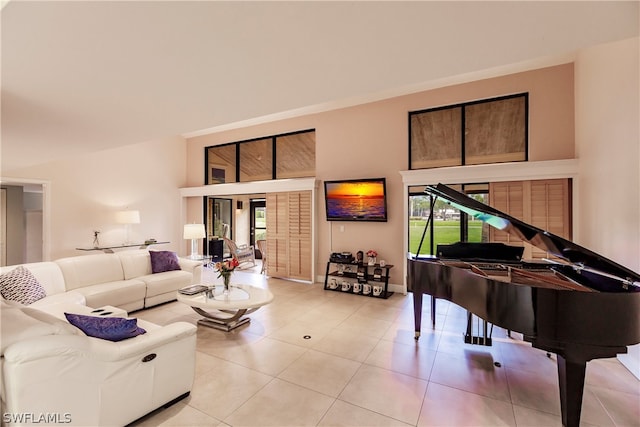 living room featuring light tile patterned flooring and a high ceiling