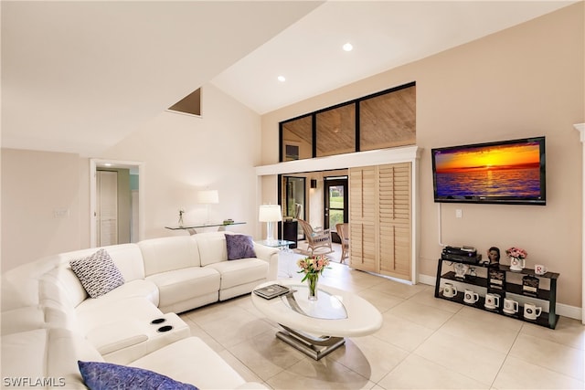 living room featuring light tile patterned flooring and high vaulted ceiling