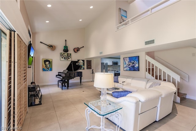 tiled living room with high vaulted ceiling