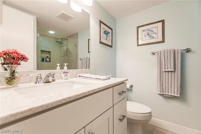 bathroom featuring tile patterned floors, vanity, and toilet