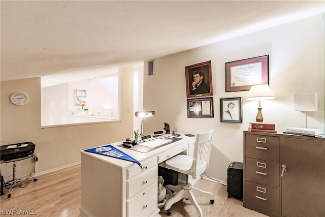 home office with light hardwood / wood-style floors