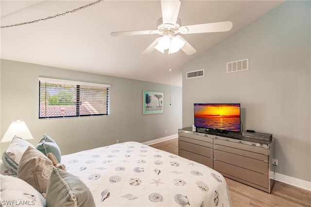 bedroom featuring ceiling fan, lofted ceiling, and light hardwood / wood-style floors