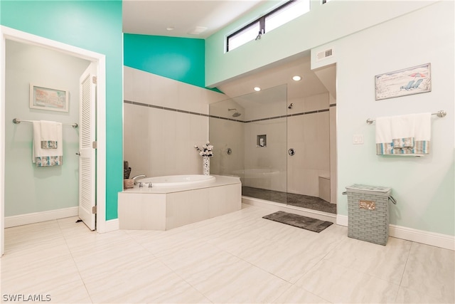 bathroom featuring independent shower and bath and tile patterned floors