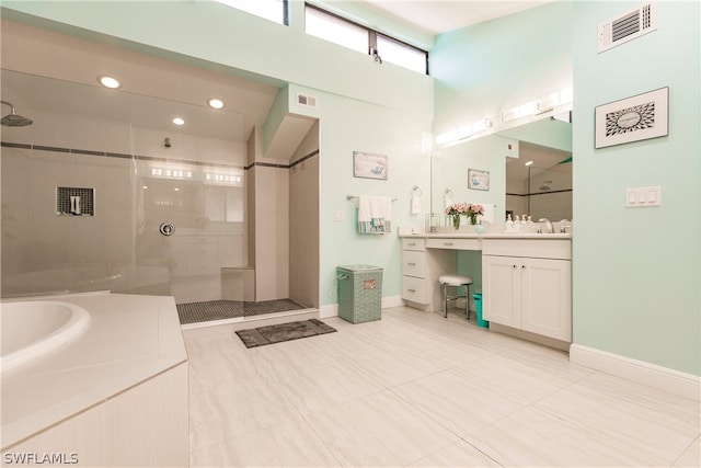 bathroom with tile patterned flooring, plus walk in shower, and vanity