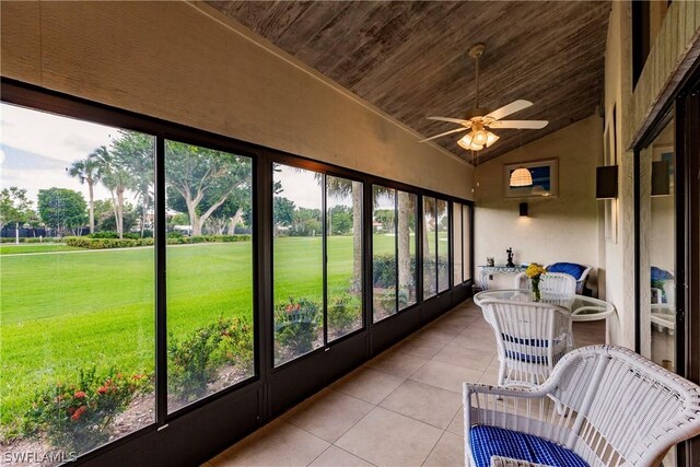 sunroom with wood ceiling, vaulted ceiling, and ceiling fan