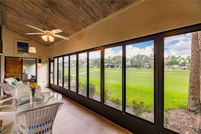 unfurnished sunroom with a healthy amount of sunlight, vaulted ceiling, wood ceiling, and ceiling fan