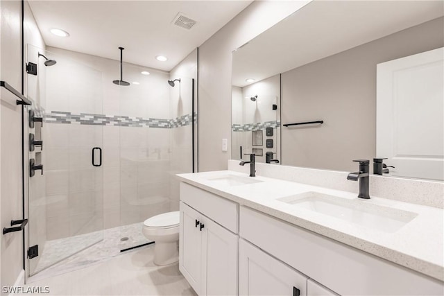 bathroom featuring vanity, toilet, and an enclosed shower