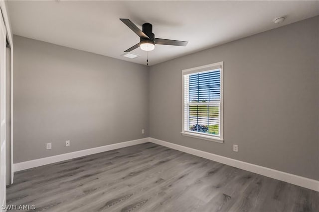 unfurnished room with hardwood / wood-style flooring and ceiling fan