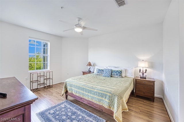 bedroom with ceiling fan and hardwood / wood-style floors