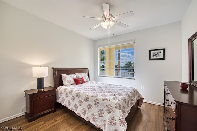 bedroom with ceiling fan and dark hardwood / wood-style flooring