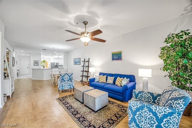 living room featuring ceiling fan and light hardwood / wood-style flooring