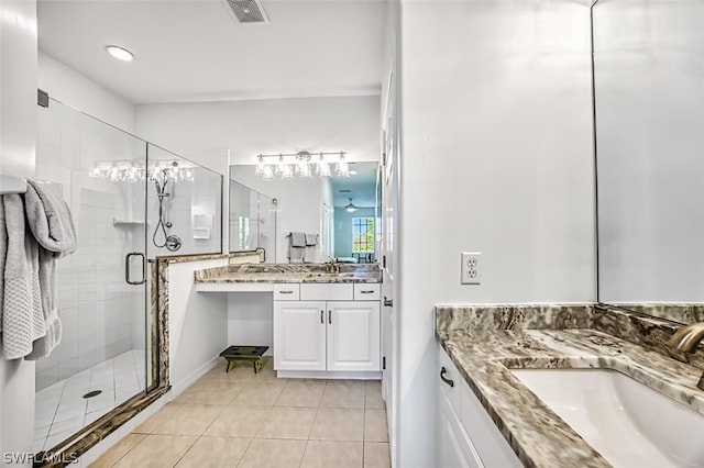 bathroom with an enclosed shower, vanity, and tile patterned floors