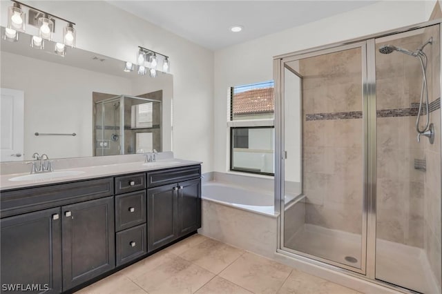 bathroom with tile patterned flooring, vanity, and separate shower and tub