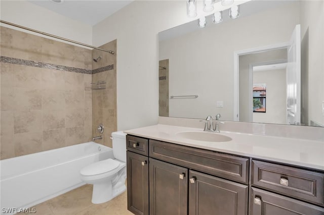 full bathroom with tiled shower / bath, vanity, toilet, and tile patterned floors