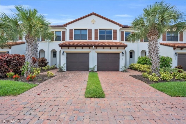 mediterranean / spanish house with a garage