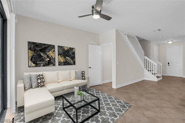 tiled living room featuring ceiling fan