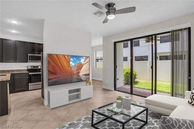 tiled living room with ceiling fan