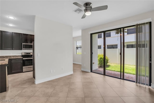 unfurnished room with light tile patterned floors and ceiling fan